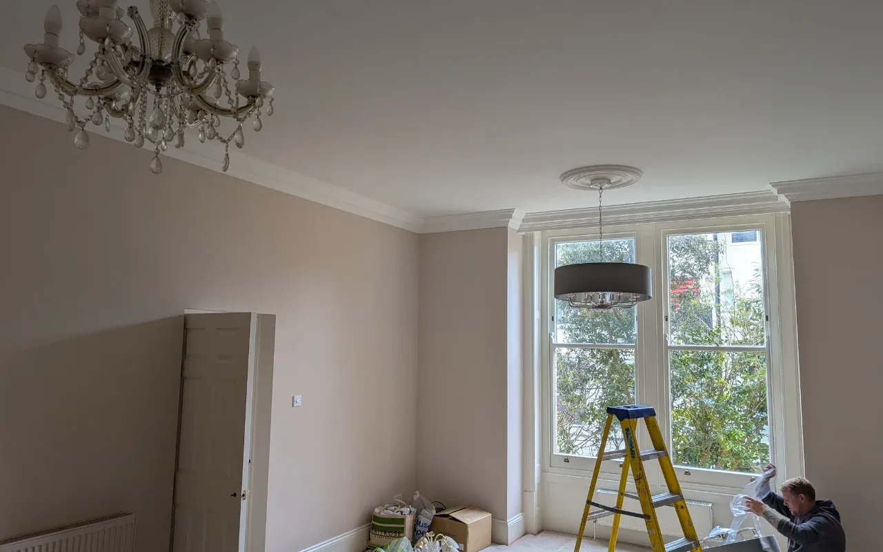Electrician fitting new light fittings in a Poole home