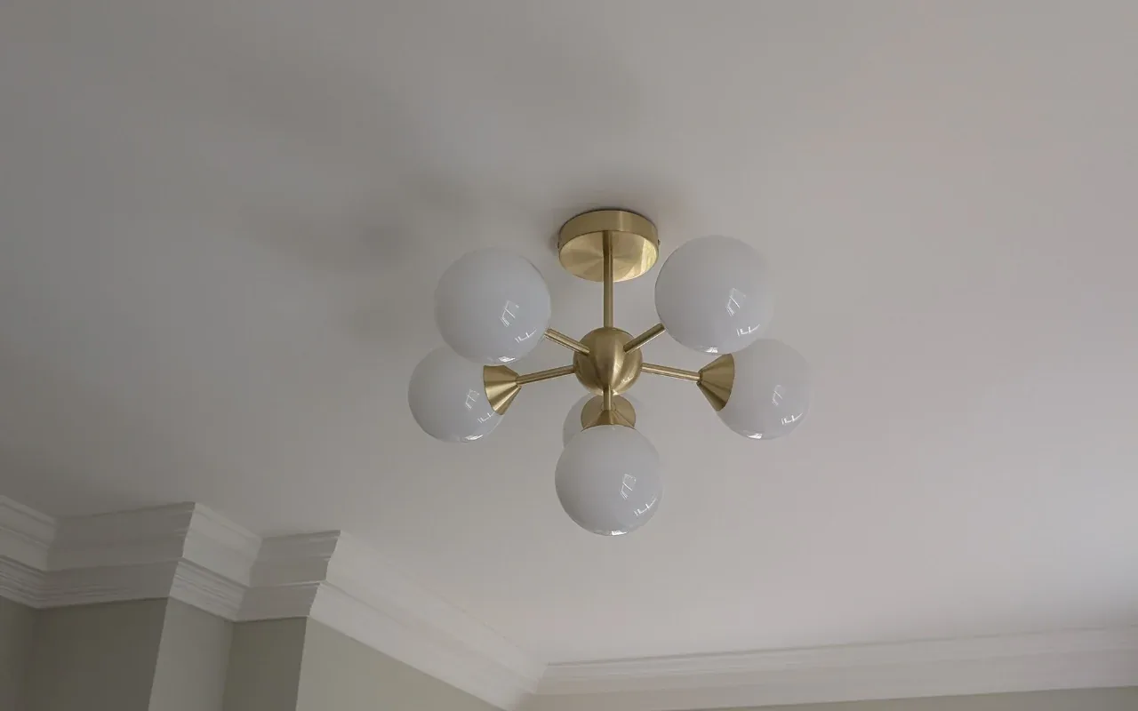 Brass five-globe ceiling light installed