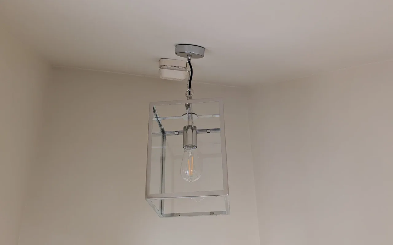 Glass lantern pendant with Edison bulb installed