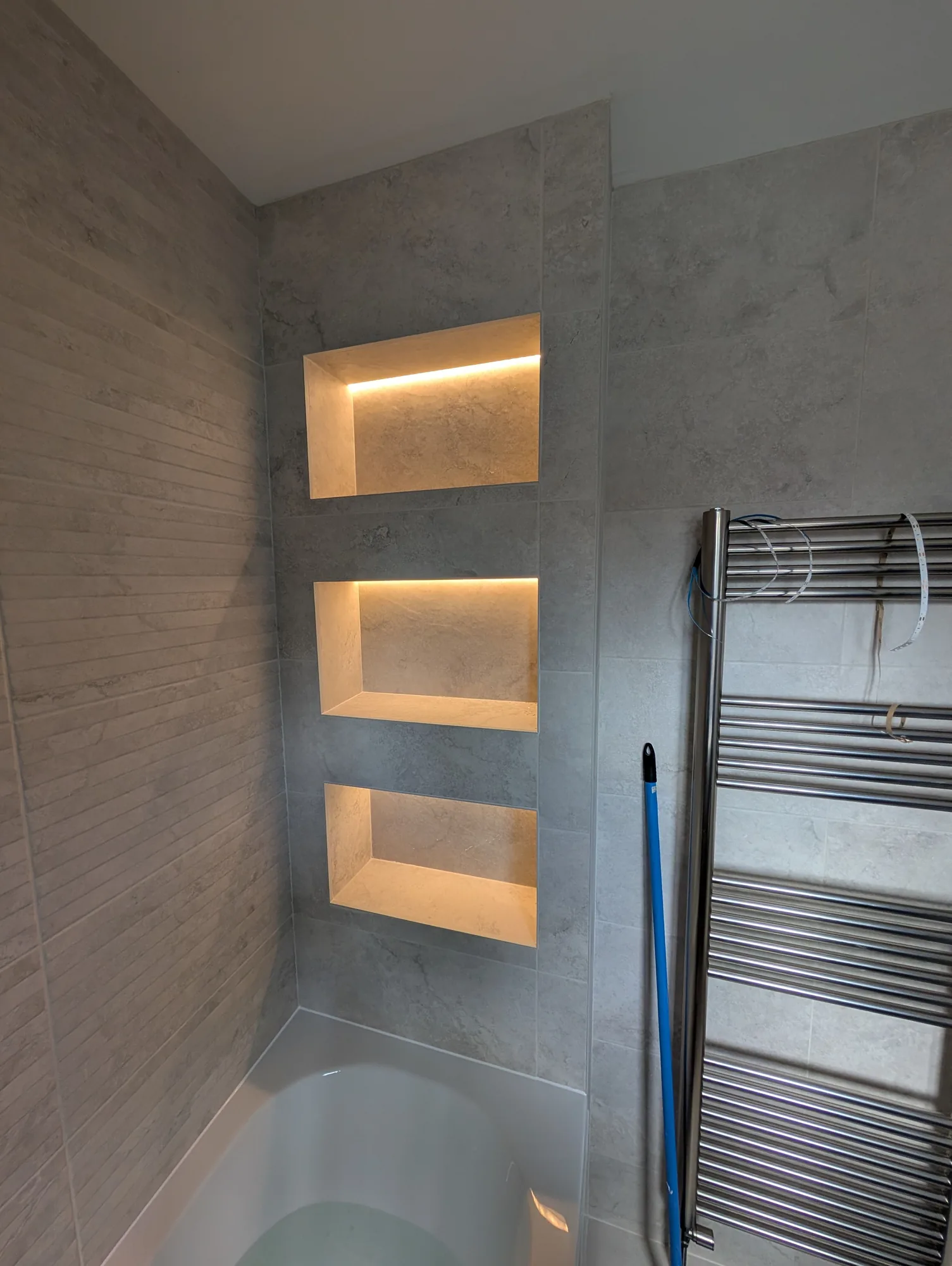 LED strip lighting fitted to tiled bathroom niches